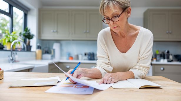 Senior woman looking at bills